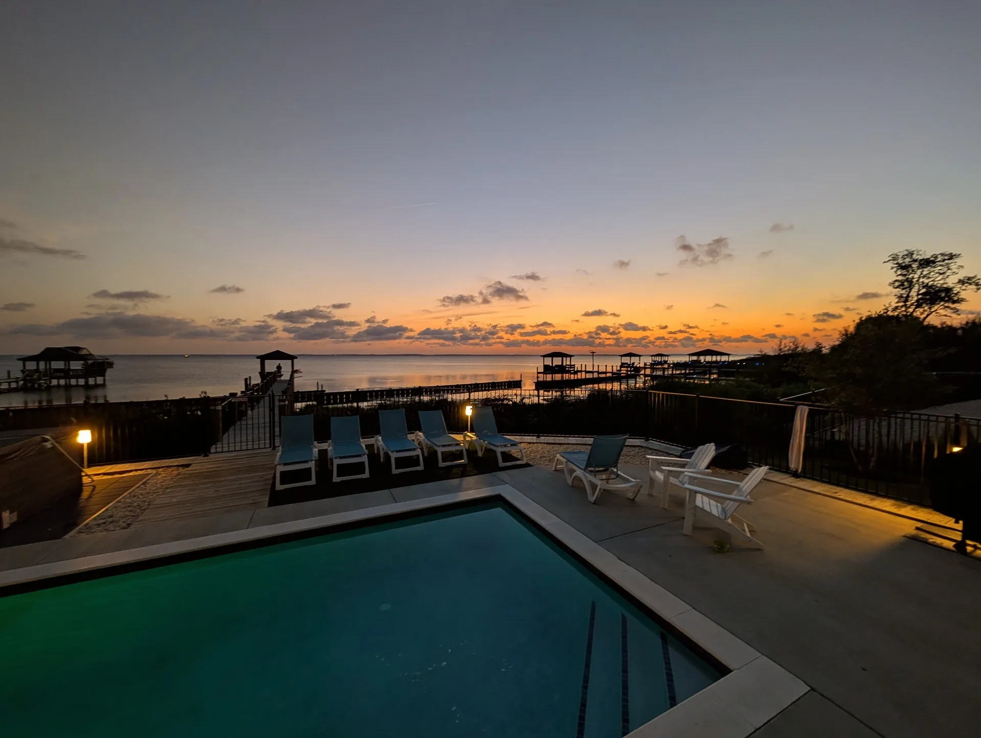 Private resort-style pool at sunset overlooking Currituck Sound at Hygge on the Bay